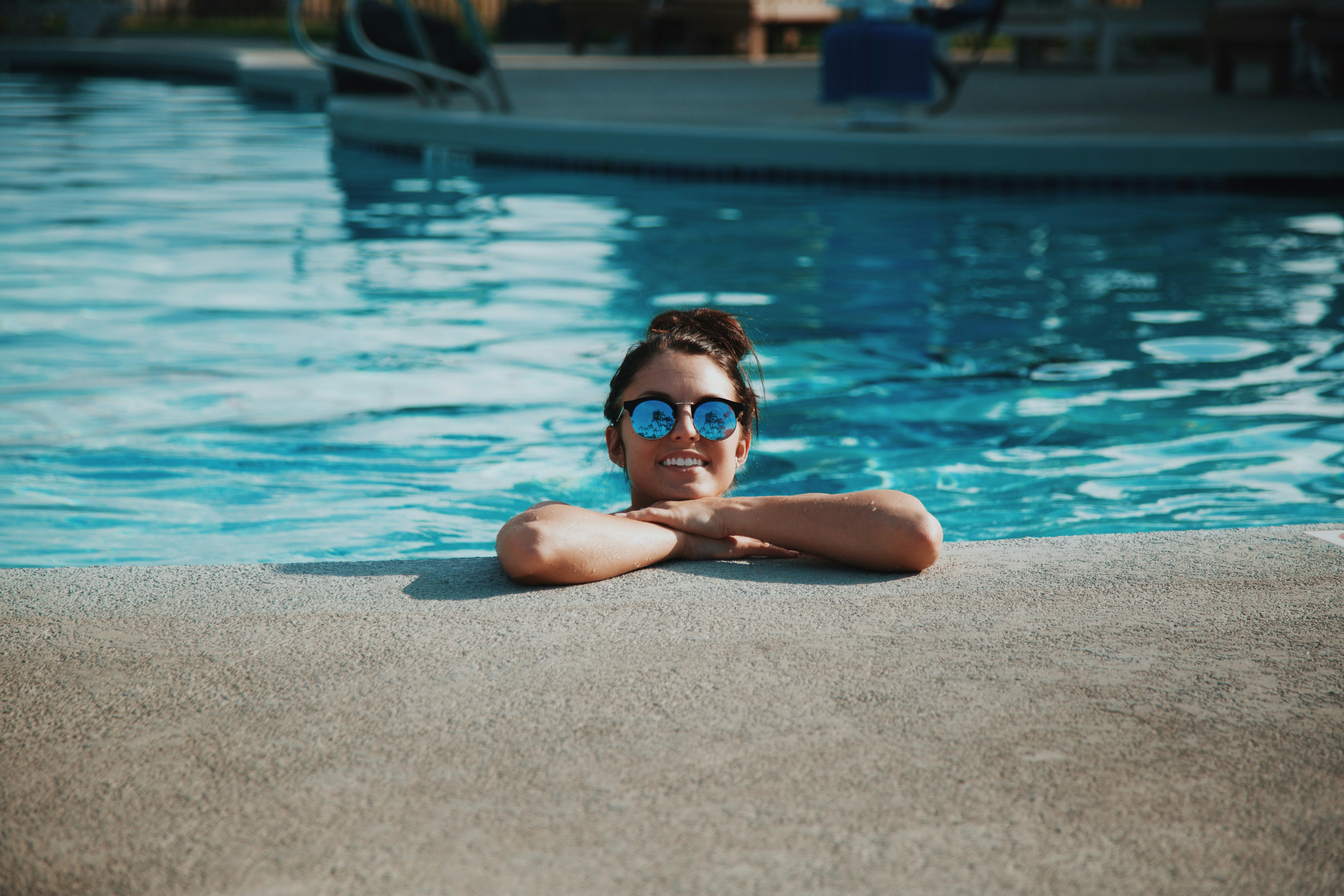 Woman smiling in the pool Woman smiling in the pool